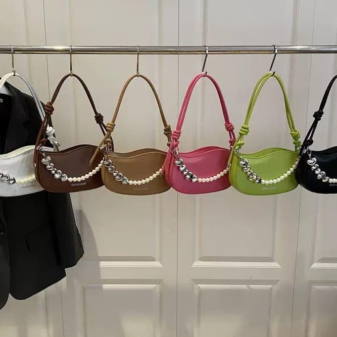 Pearl Knot Crescent Shoulder Bag" or "Hobo Chain Clutch"